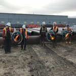 A crew cutting pipes