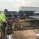 Employee threading a pipe